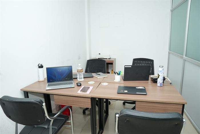 The empty Begnas team cabin at Stratex, set up with laptops around a shared table