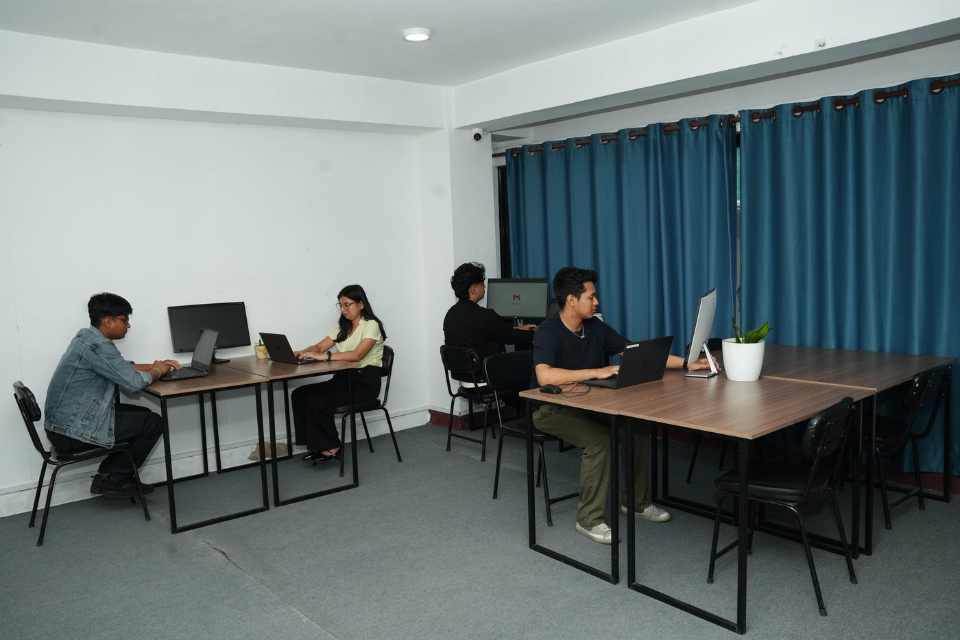 Members working at dedicated desks on the open third floor at Stratex