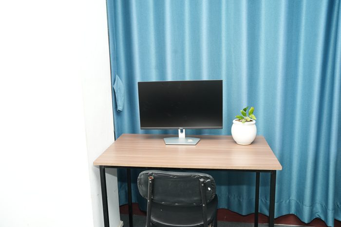 A single dedicated desk with monitor and chair on the third floor at Stratex