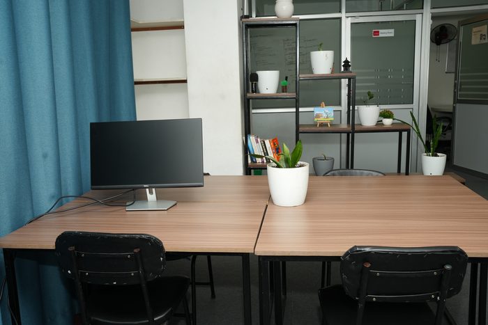 Desks on the third floor at Stratex beside the shelving and the meeting room door