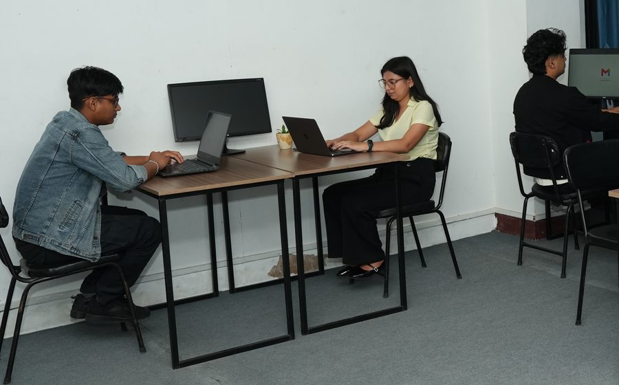 Two members at the wall desks on the open third floor at Stratex