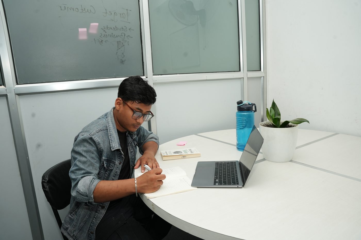A member working at the table in the Gokya private cabin at Stratex
