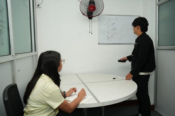 Two members at the whiteboard in the Gokya cabin at Stratex