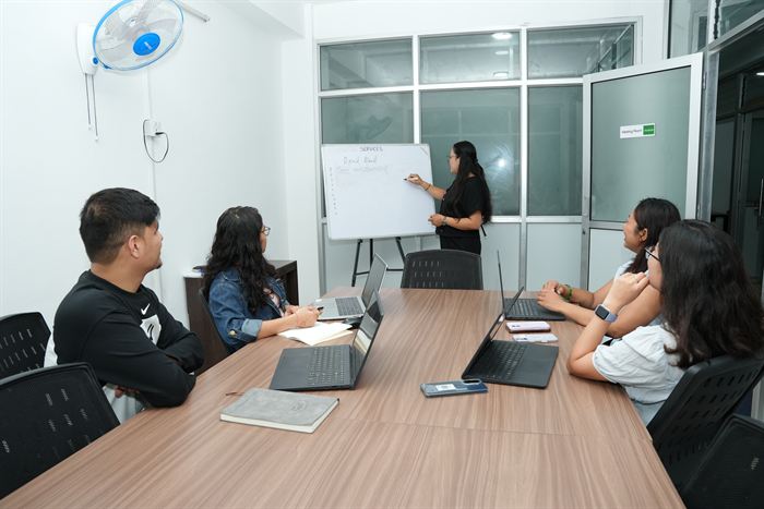 A team meeting at the whiteboard in the Gosaikunda cabin at Stratex