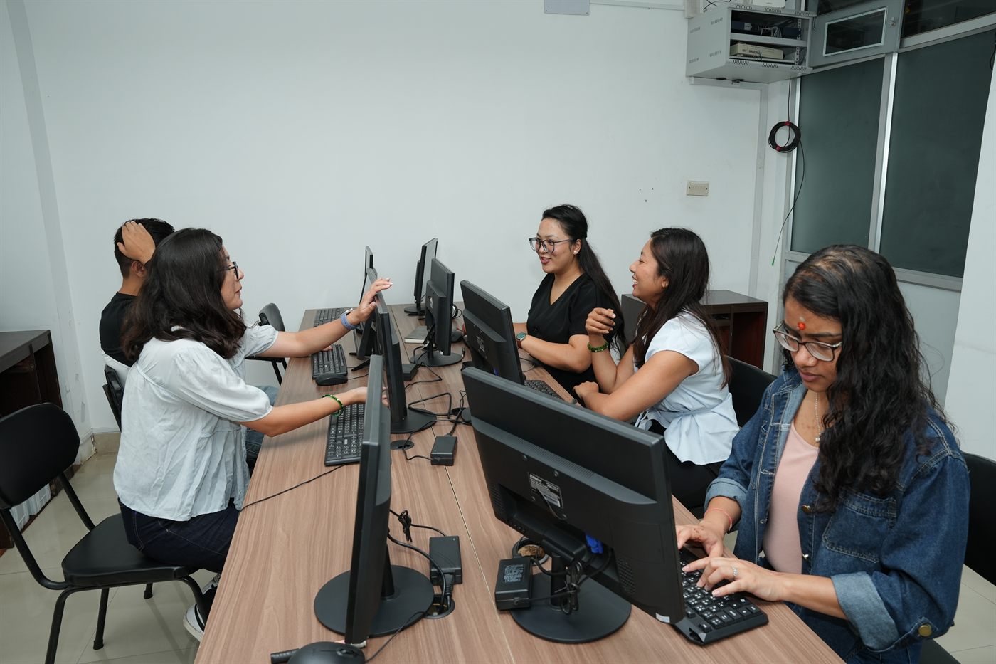 Members at rows of workstations in the Rupa team cabin at Stratex